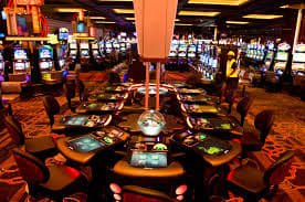 Live-dealer table on olenations showing real dealer and virtual chip interface